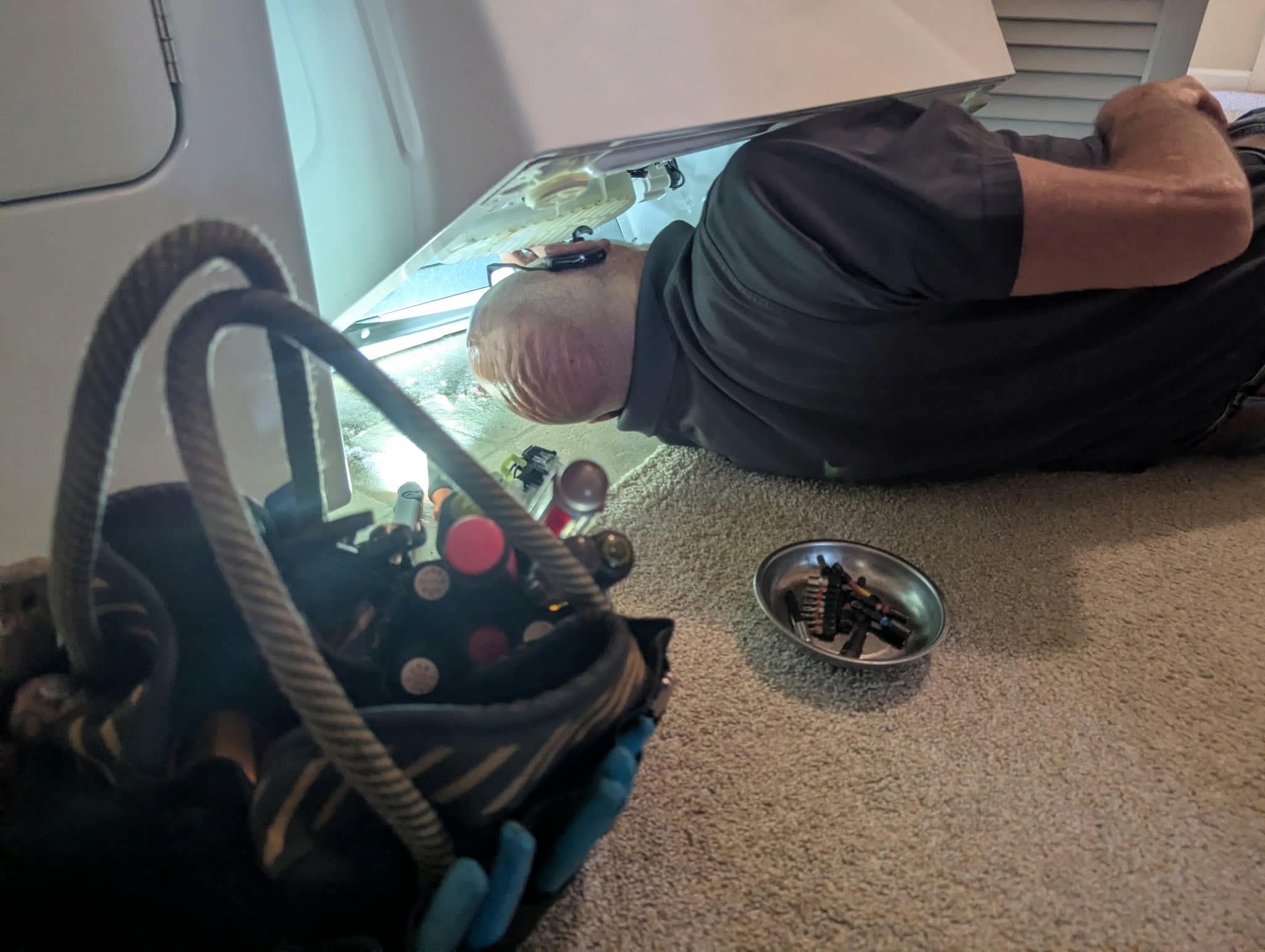 Brad Howard repairing a refrigerator in Lexington, SC
